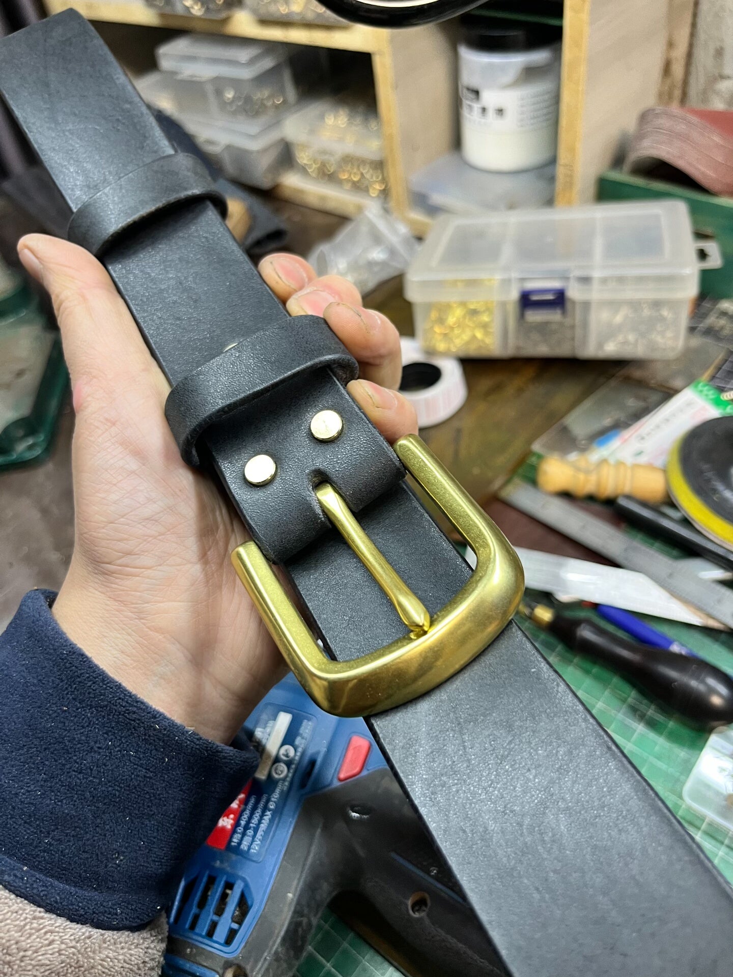 A dozen slightly blemished bison leather belts