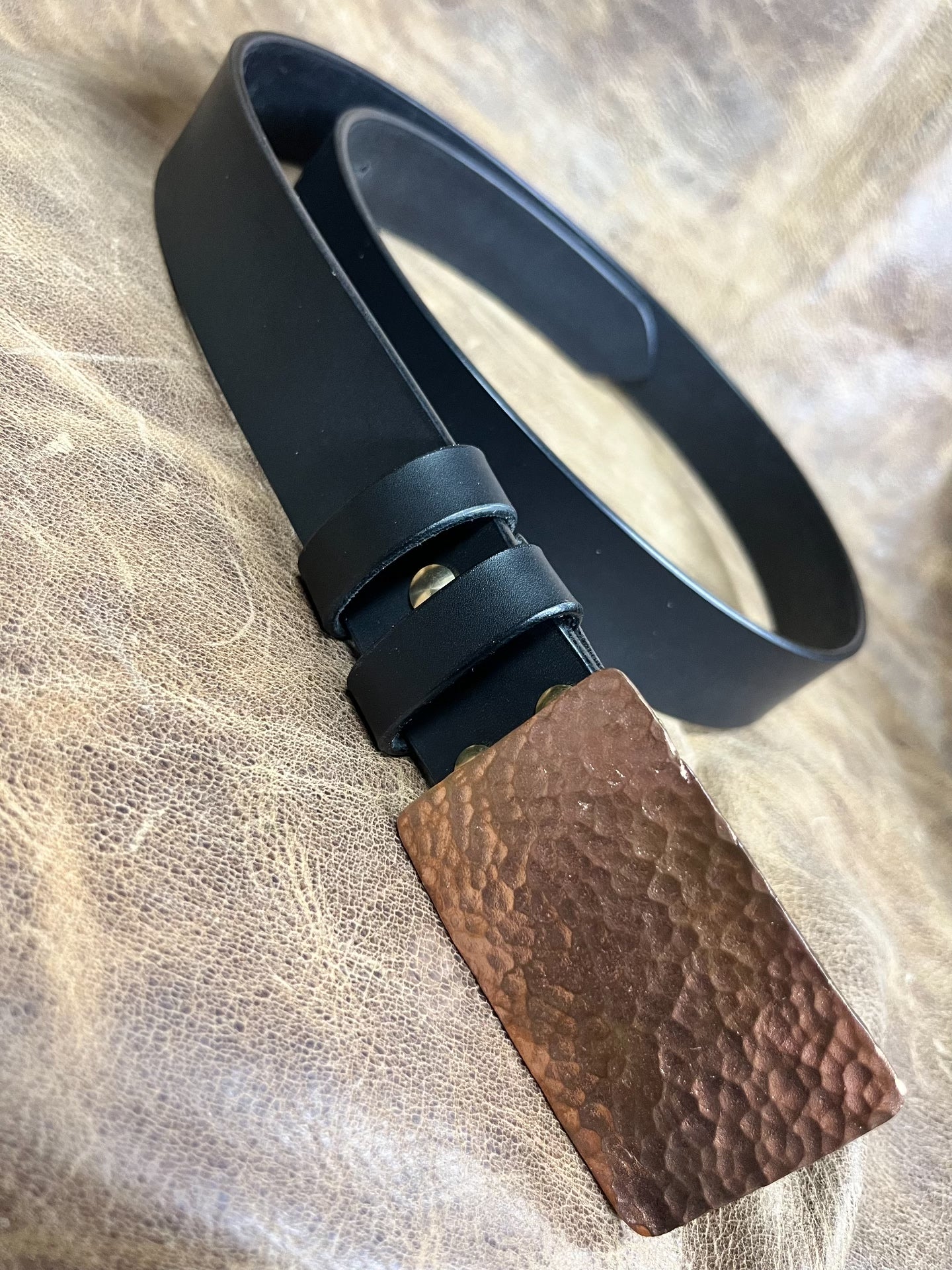 The copper hammered smooth gusset buckle is paired with a custom-ma…