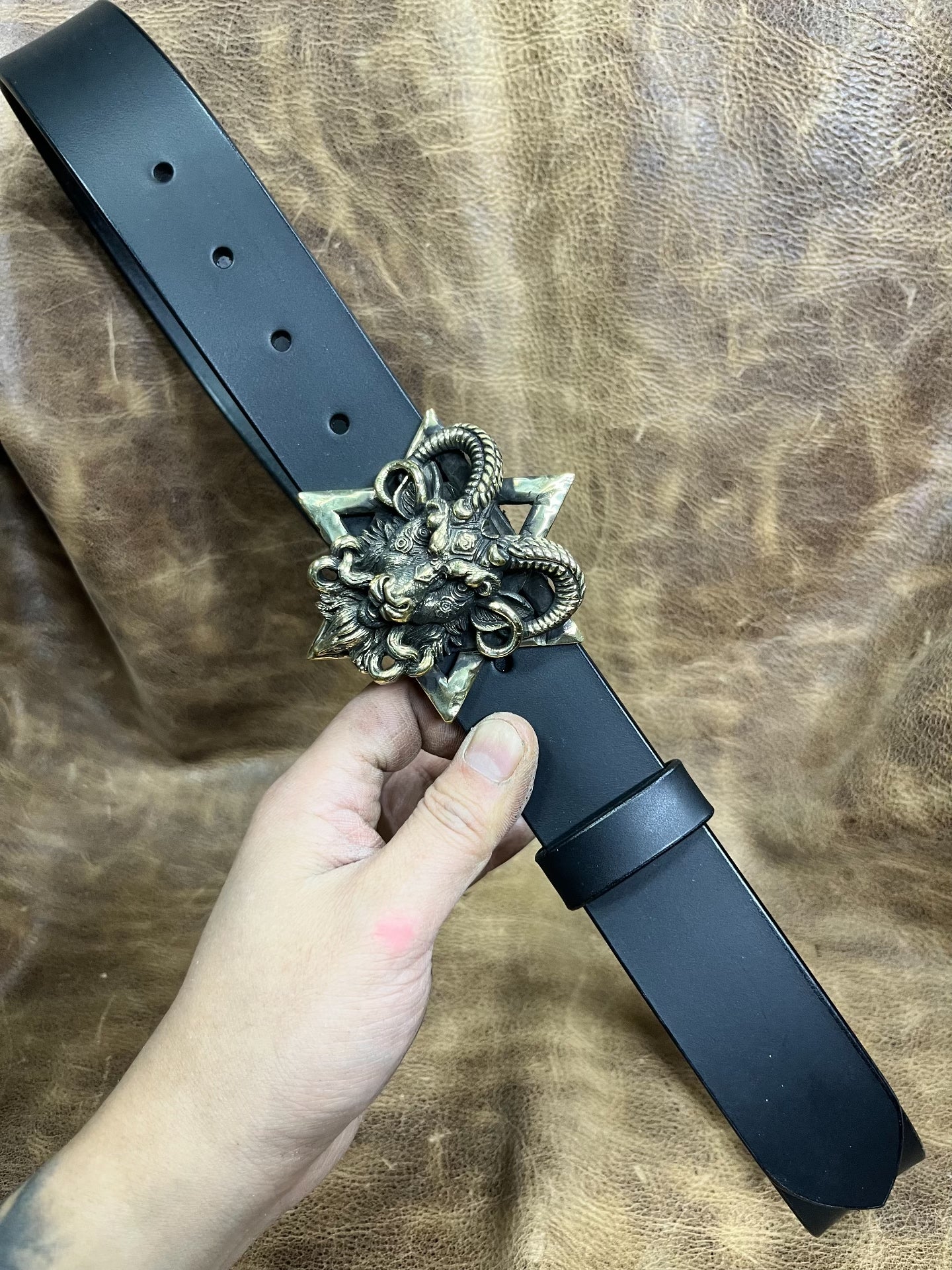 The three-dimensional Pan God smooth buckle is paired with a custom…