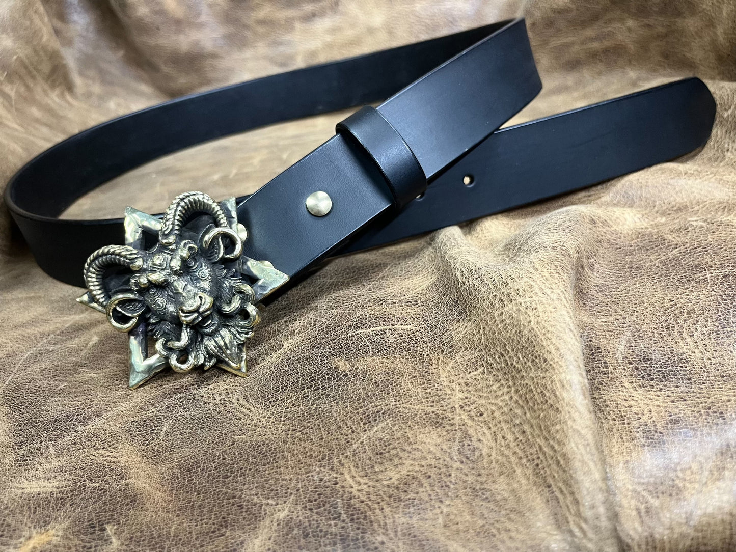 The three-dimensional Pan God smooth buckle is paired with a custom…