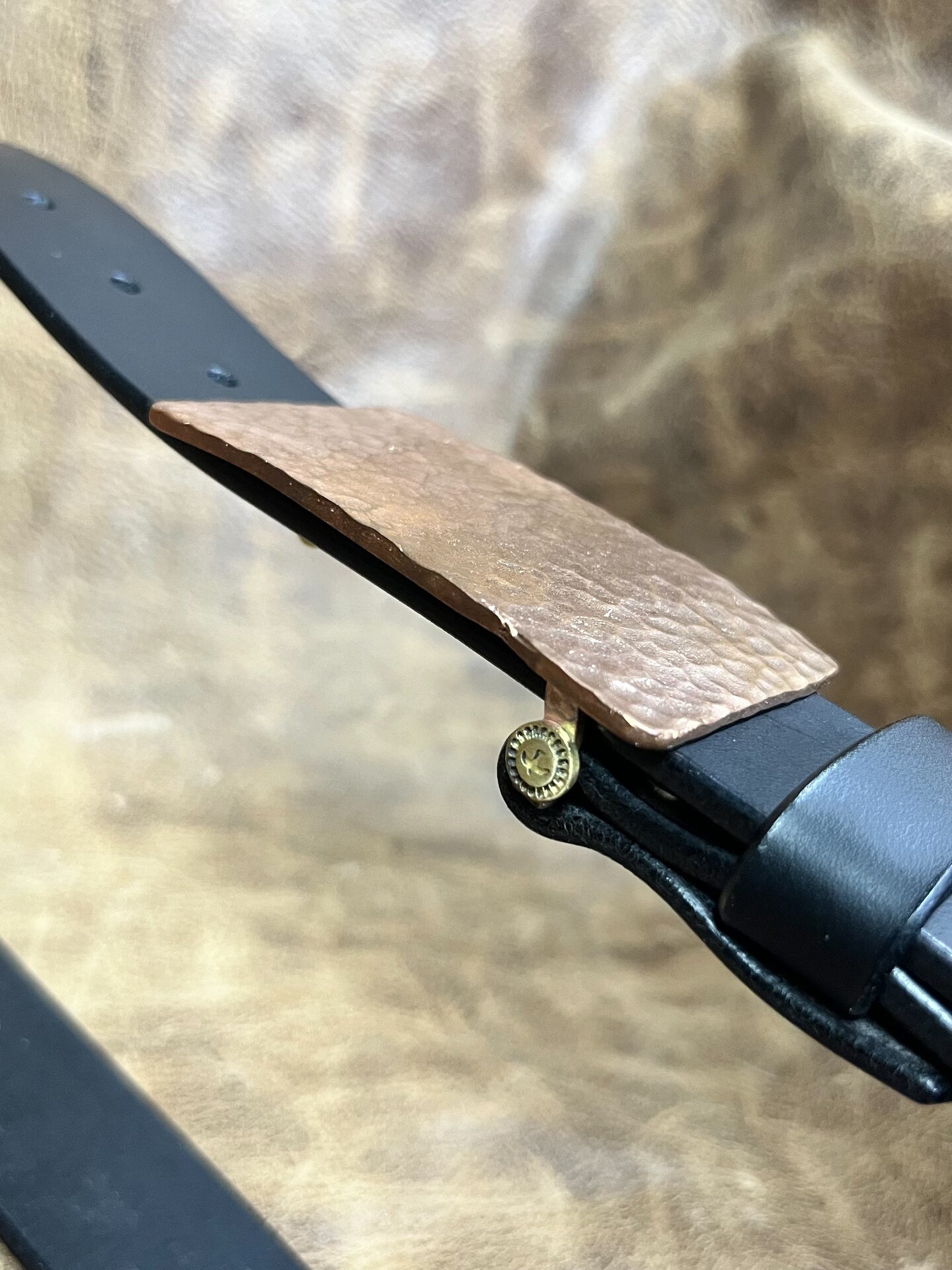 The copper hammered smooth gusset buckle is paired with a custom-ma…