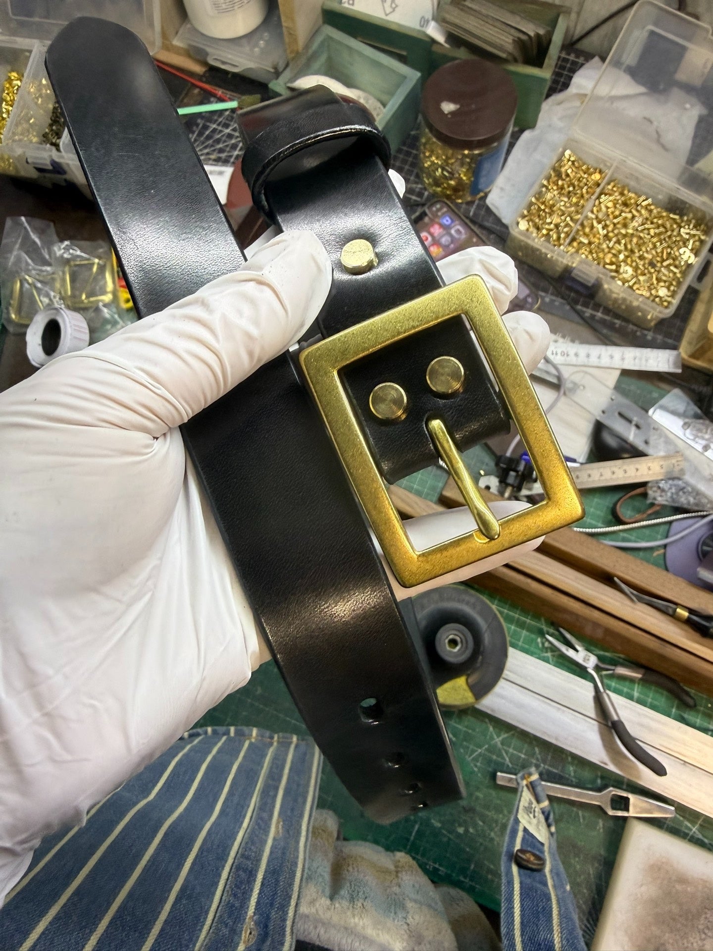 More than a dozen pairs of women's oil-waxed leather belts with sli…