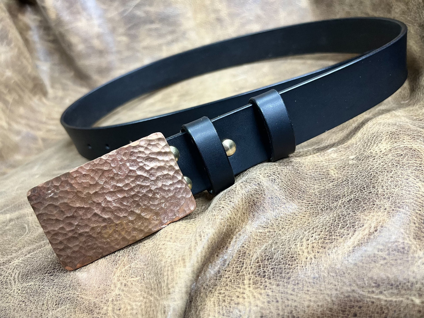 The copper hammered smooth gusset buckle is paired with a custom-ma…