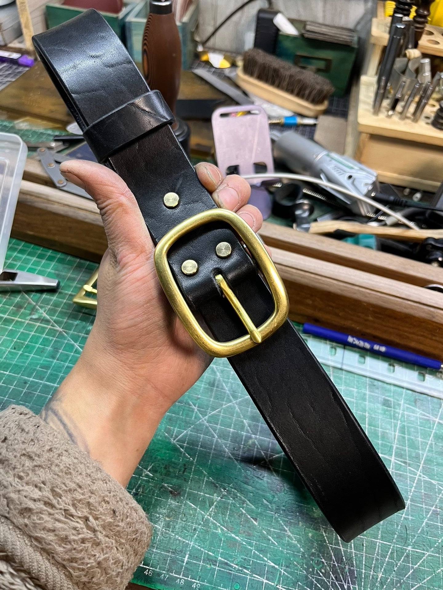 A dozen slightly blemished bison leather belts