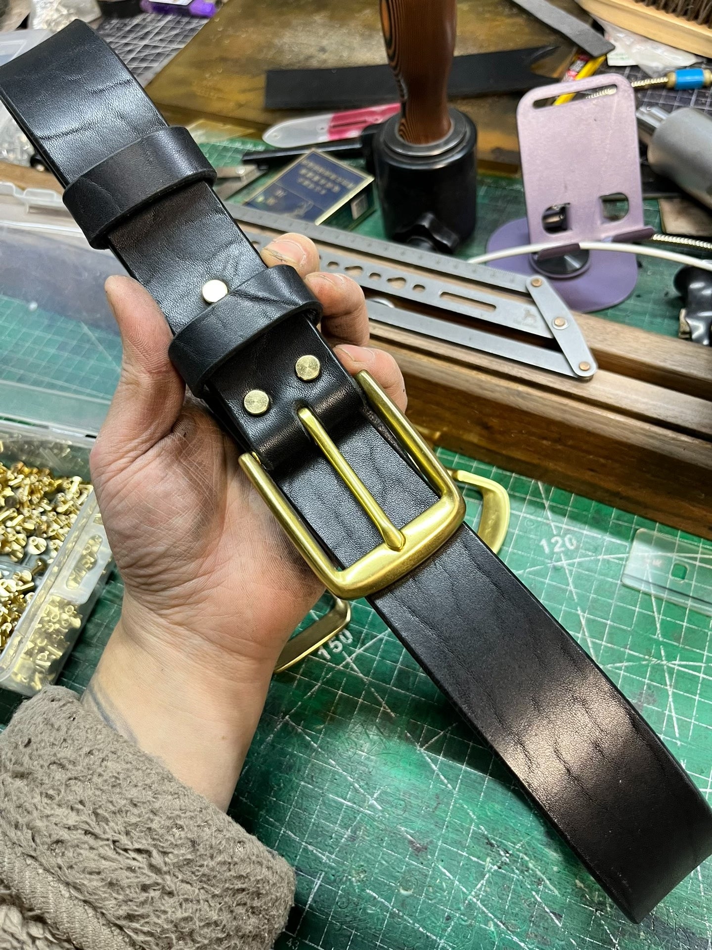 A dozen slightly blemished bison leather belts