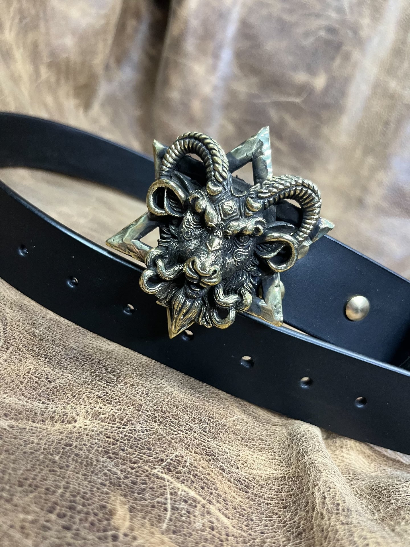 The three-dimensional Pan God smooth buckle is paired with a custom…