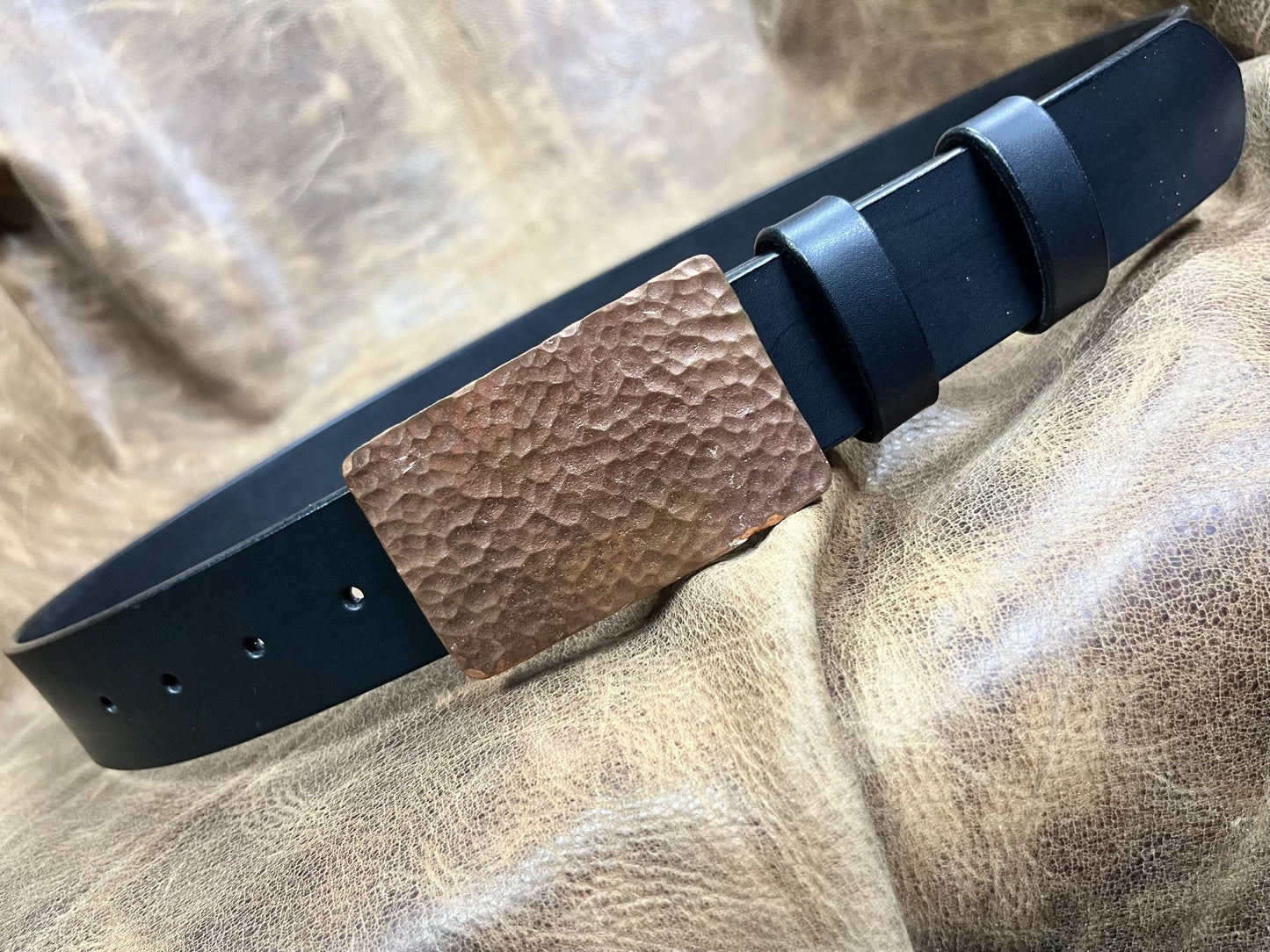 The copper hammered smooth gusset buckle is paired with a custom-ma…