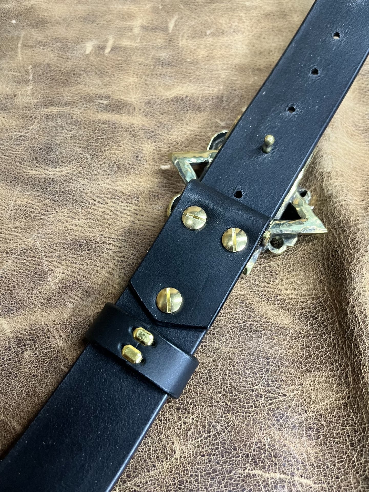 The three-dimensional Pan God smooth buckle is paired with a custom…