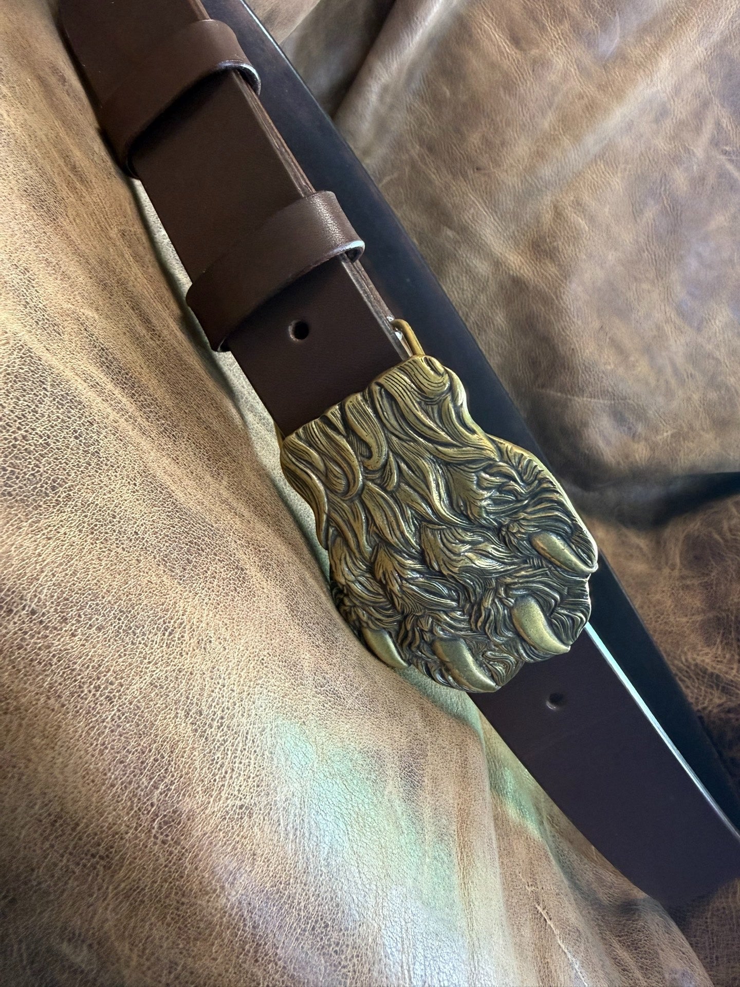 Brass embossed bear claw belt buckle with brown saddle