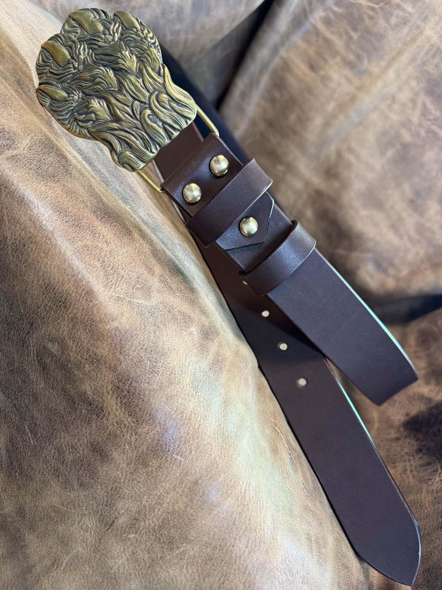 Brass embossed bear claw belt buckle with brown saddle
