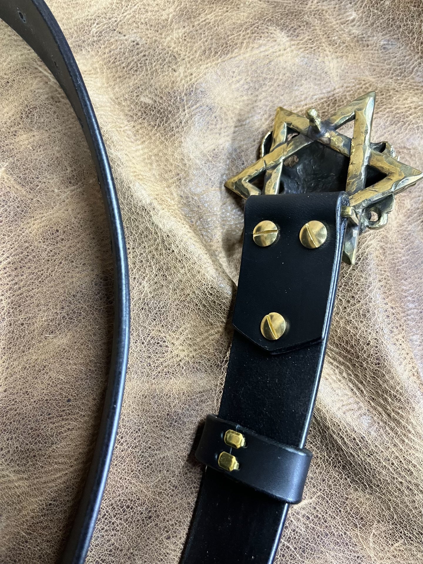 The three-dimensional Pan God smooth buckle is paired with a custom…