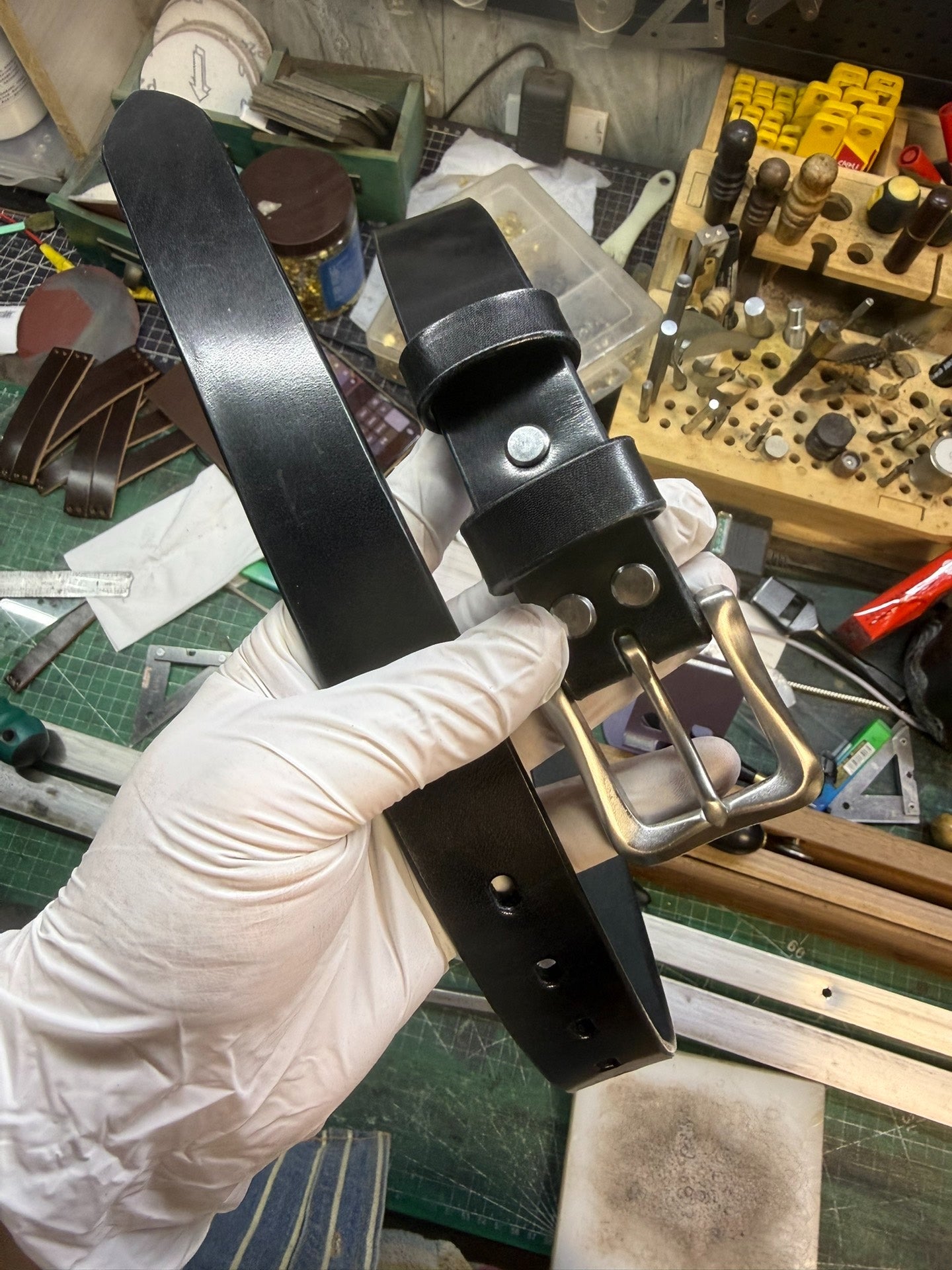 More than a dozen pieces of women's oil-waxed leather belts with sl…