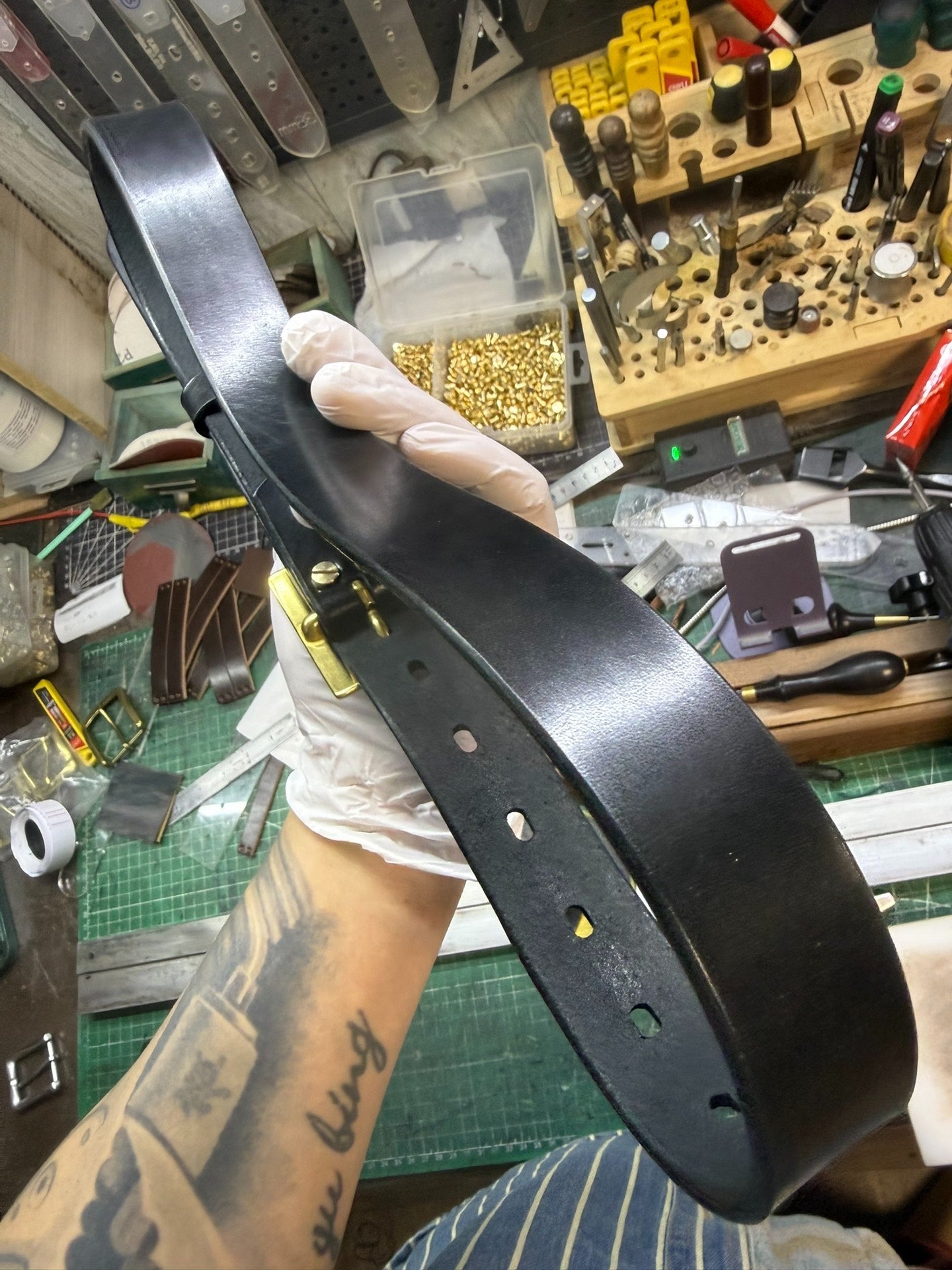 More than a dozen pairs of women's oil-waxed leather belts with sli…