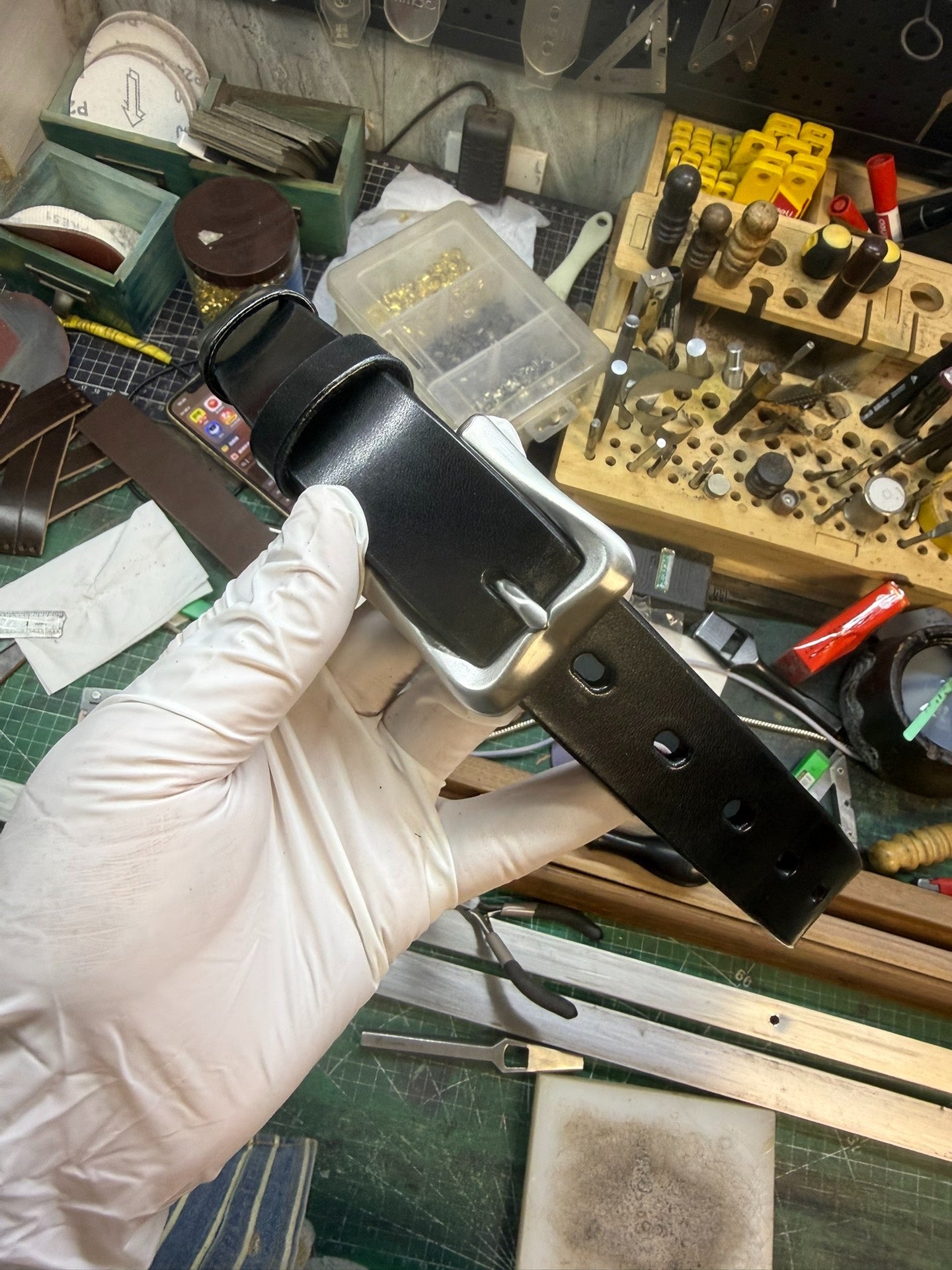 More than a dozen pieces of women's oil-waxed leather belts with sl…