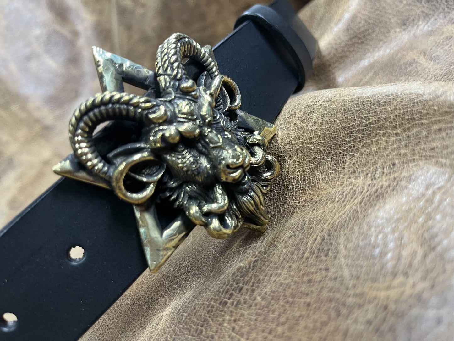 The three-dimensional Pan God smooth buckle is paired with a custom…