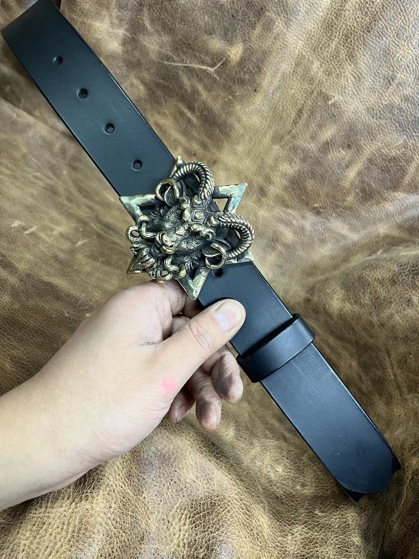 The three-dimensional Pan God smooth buckle is paired with a custom…