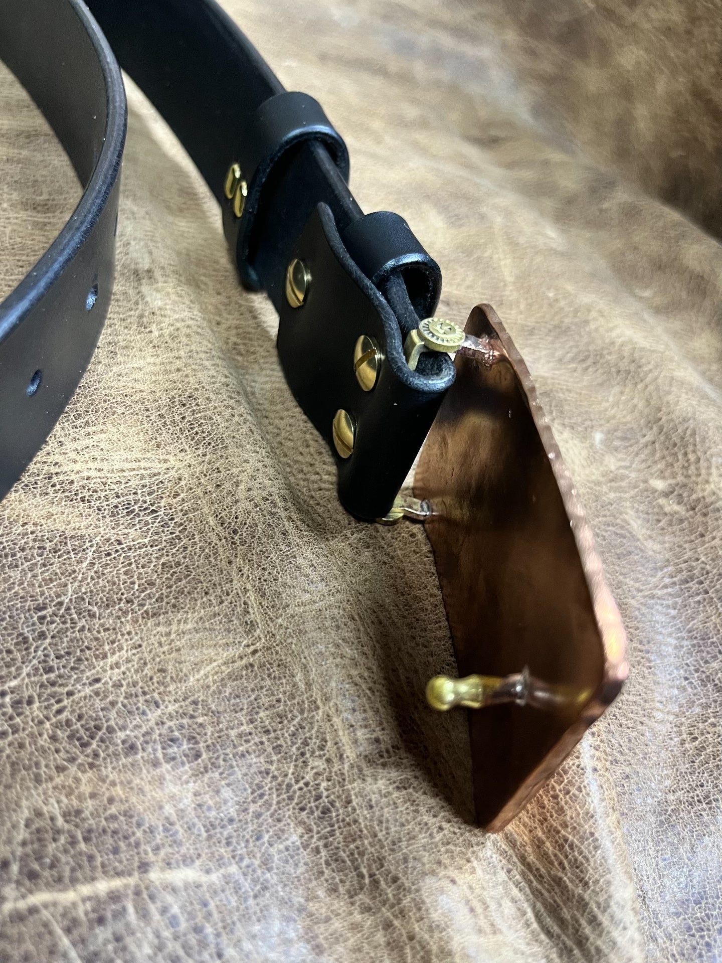 The copper hammered smooth gusset buckle is paired with a custom-ma…