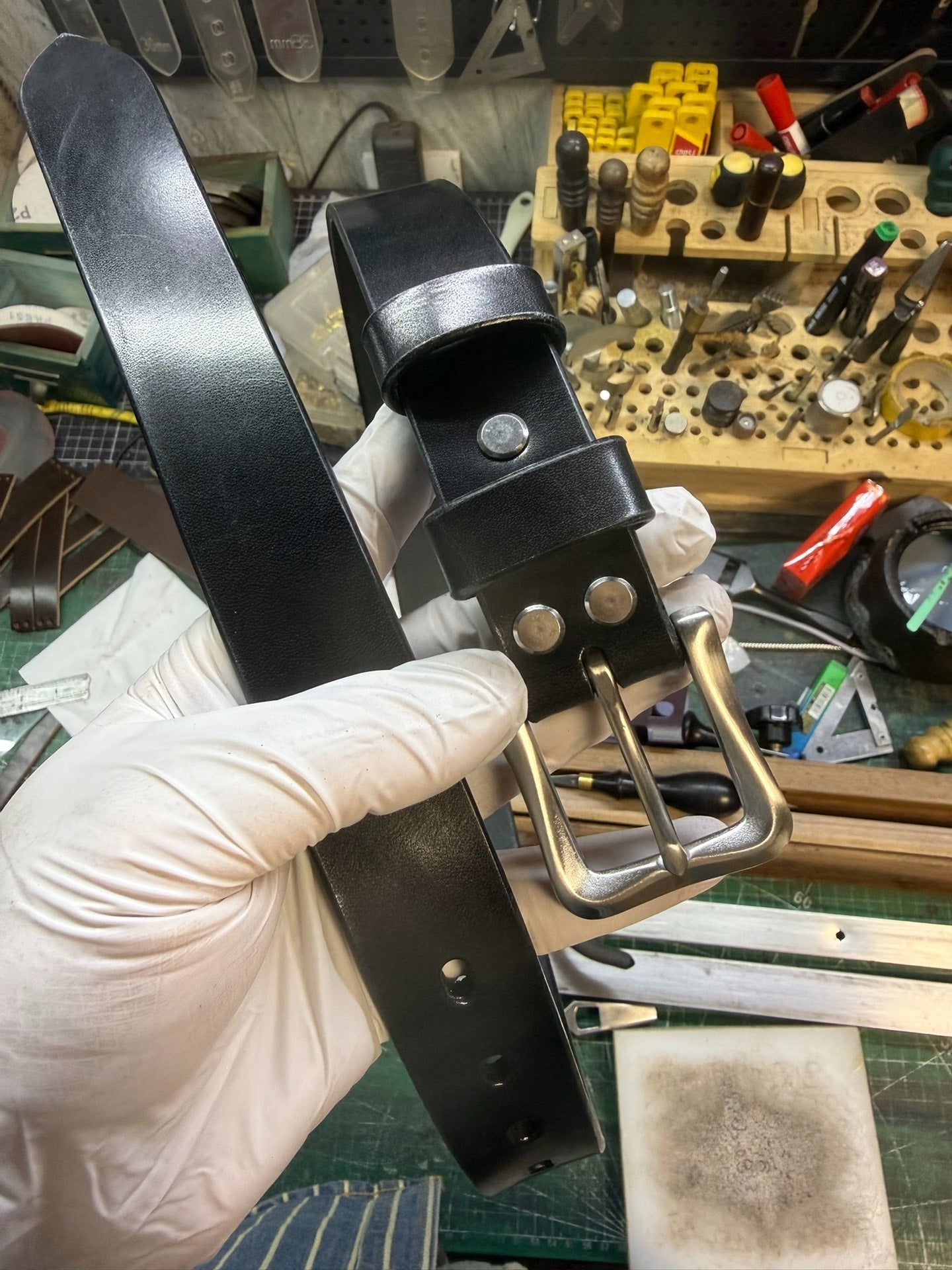 More than a dozen pieces of women's oil-waxed leather belts with sl…