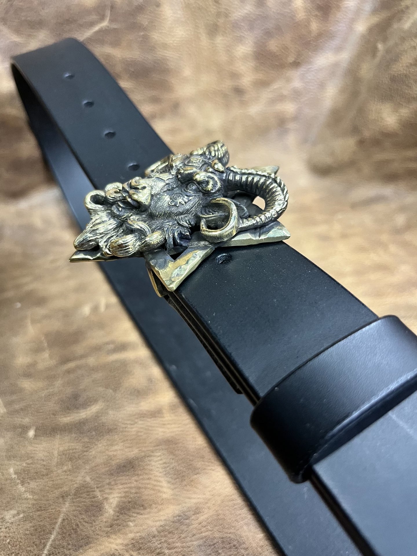 The three-dimensional Pan God smooth buckle is paired with a custom…
